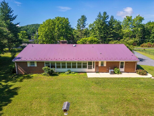 192 Sandy Ridge Rd, Waynesboro, VA 22801 - back of property with brick siding, a patio area, a metal roof, and a lawn