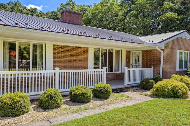 192 Sandy Ridge Rd, Waynesboro, VA 22801 - view of front of house with covered porch, brick siding, a chimney, and a metal roof