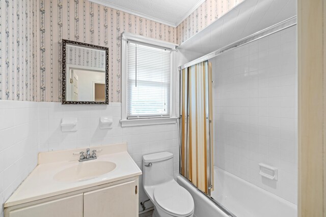 192 Sandy Ridge Rd, Waynesboro, VA 22801 - bathroom with wallpapered walls, vanity, ornamental molding, and bath / shower combo with glass door
