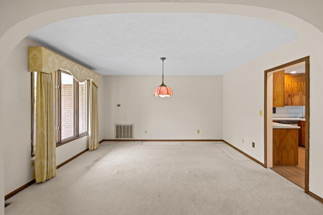 192 Sandy Ridge Rd, Waynesboro, VA 22801 - empty room featuring light colored carpet, arched walkways, and a textured ceiling