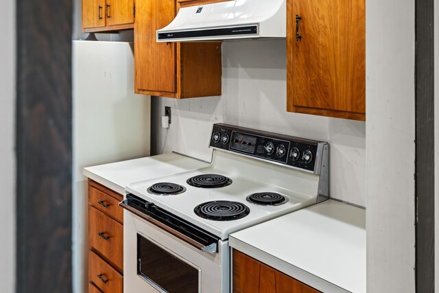192 Sandy Ridge Rd, Waynesboro, VA 22801 - kitchen with white electric range oven, ventilation hood, brown cabinets, and light countertops