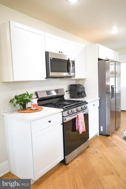 kitchen featuring white cabinetry, stainless steel appliances, and light hardwood / wood-style floors