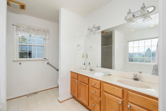 49 Bridgeport Dr, Waynesboro, VA 22980 - bathroom featuring tile patterned floors, double vanity, healthy amount of natural light, and a shower with shower door