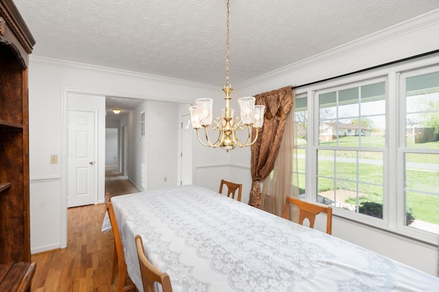 49 Bridgeport Dr, Waynesboro, VA 22980 - dining room featuring a chandelier, light wood-type flooring, crown molding, and a textured ceiling
