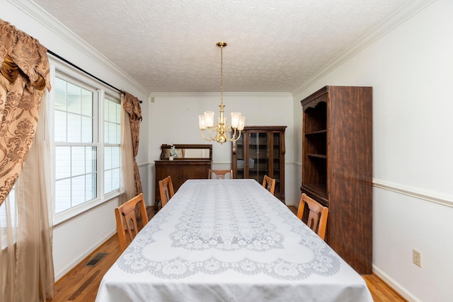 49 Bridgeport Dr, Waynesboro, VA 22980 - dining room featuring a chandelier, healthy amount of natural light, wood finished floors, a textured ceiling, and baseboards