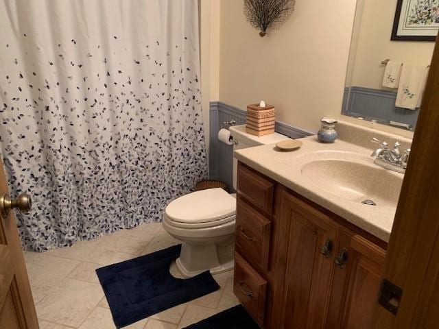 625 Hummingbird Ln, Monterey, VA 24465 - full bath featuring vanity, toilet, tile patterned flooring, a wainscoted wall, and a shower with shower curtain