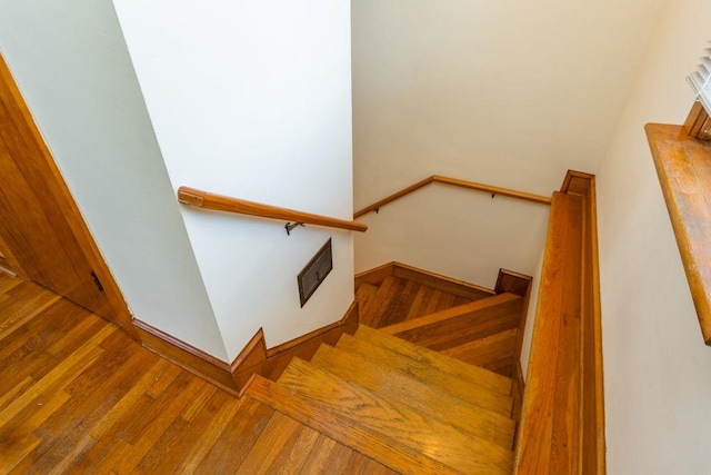 stairs featuring wood-type flooring