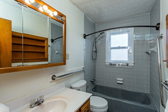 full bathroom with tiled shower / bath, vanity, a textured ceiling, and toilet