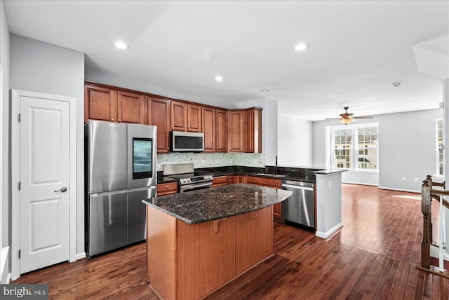 4631 Alliance Way, Fredericksburg, VA 22408 - kitchen with stainless steel appliances, a peninsula, a center island, dark wood-style floors, and recessed lighting