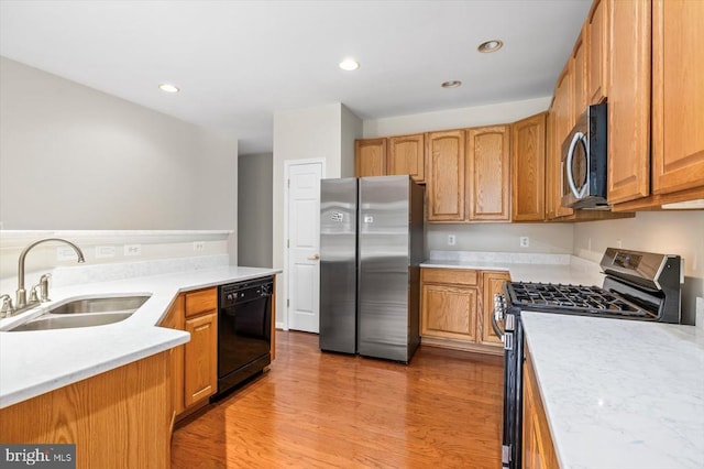 5307 Philippi Pl W, Fredericksburg, VA 22407 - kitchen featuring stainless steel appliances, light countertops, light wood finished floors, recessed lighting, and brown cabinetry