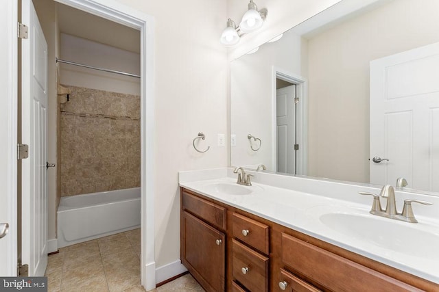 bathroom with baseboards, double vanity, tile patterned flooring, and shower / bathtub combination