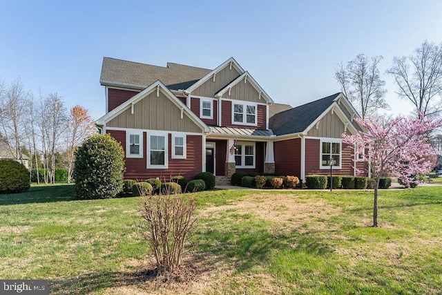 craftsman-style house with a front yard, board and batten siding, and a standing seam roof