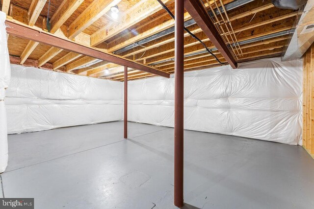 empty room with arched walkways, vaulted ceiling, baseboards, and dark wood-style flooring