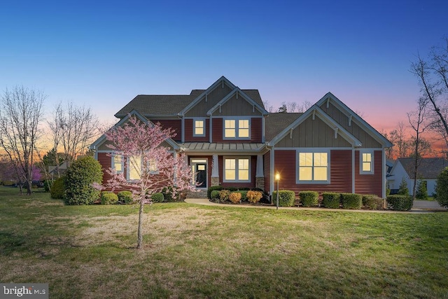 craftsman house featuring board and batten siding and a front lawn