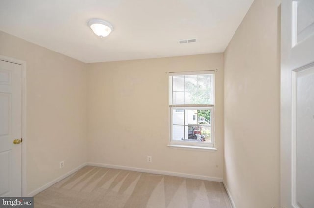 empty room with baseboards and light carpet