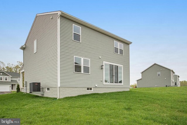 rear view of house featuring a yard and crawl space