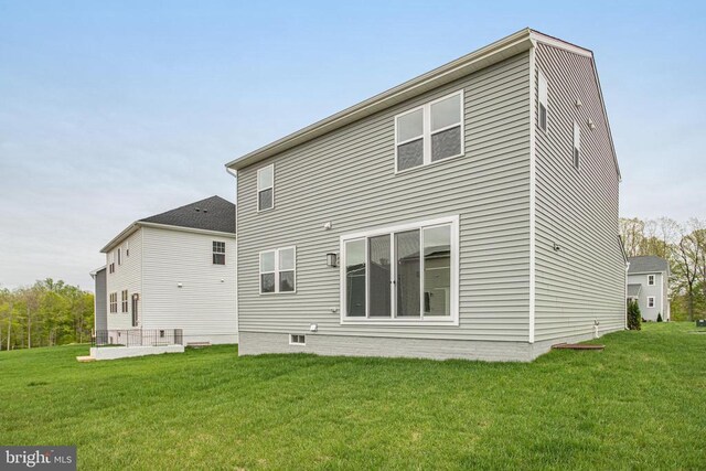back of house with a yard
