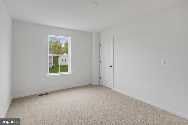 empty room with carpet flooring and baseboards