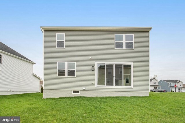 back of property featuring a yard