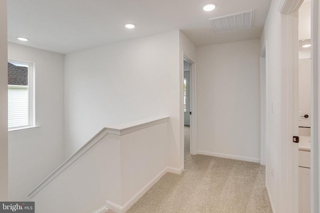 hallway with an upstairs landing, carpet, recessed lighting, and baseboards