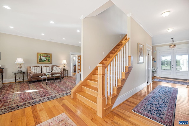 2055 Thomas Jefferson Pkwy, Charlottesville, VA 22902 - foyer entrance featuring wood finished floors, baseboards, ornamental molding, and stairs