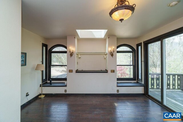 7035 Blackwells Hollow Rd, Crozet, VA 22932 - unfurnished room with wood-type flooring, a skylight, plenty of natural light, and baseboards