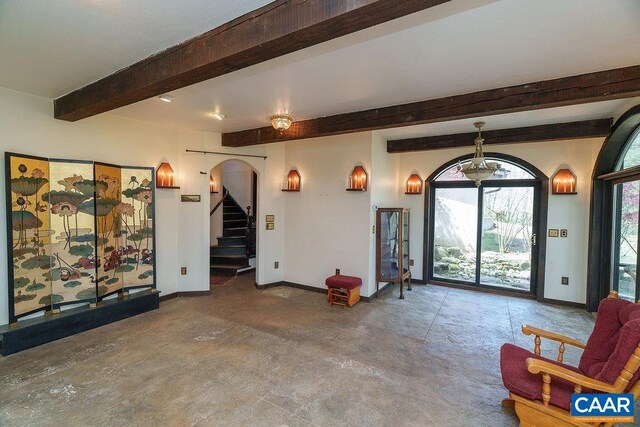 7035 Blackwells Hollow Rd, Crozet, VA 22932 - foyer entrance featuring beamed ceiling, stairs, baseboards, arched walkways, and concrete flooring