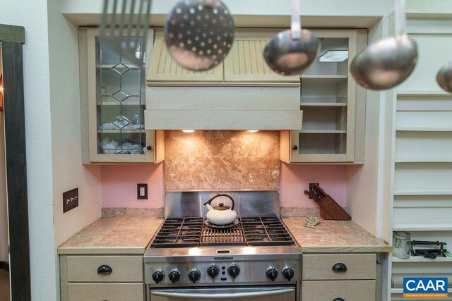 7035 Blackwells Hollow Rd, Crozet, VA 22932 - kitchen with stainless steel stove, glass insert cabinets, and backsplash