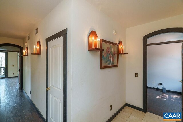 7035 Blackwells Hollow Rd, Crozet, VA 22932 - corridor with arched walkways, baseboards, and light wood-type flooring
