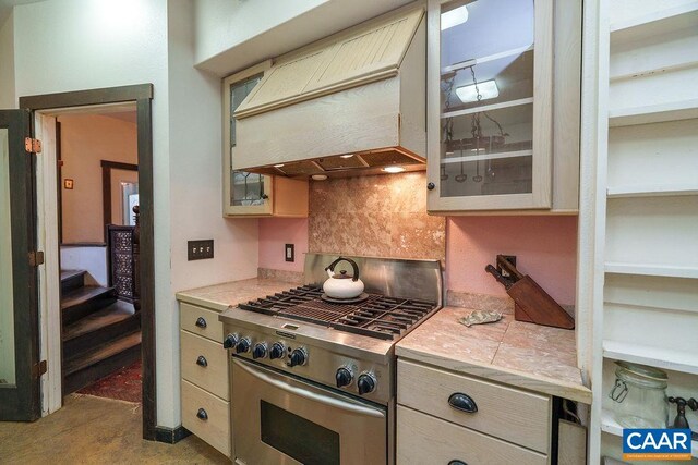 7035 Blackwells Hollow Rd, Crozet, VA 22932 - kitchen featuring high end stainless steel range oven, premium range hood, glass insert cabinets, concrete floors, and tile counters