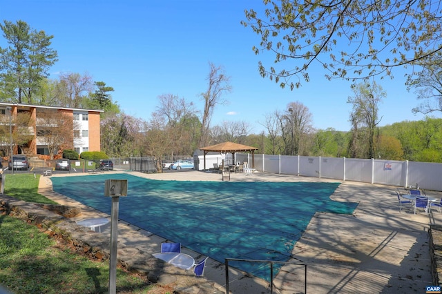 community pool featuring a patio area and fence