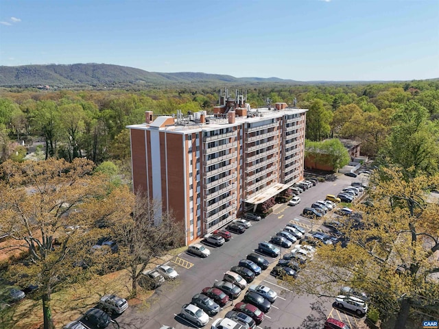 drone / aerial view featuring a wooded view