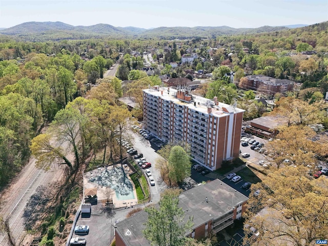 drone / aerial view featuring a view of trees and a mountain view