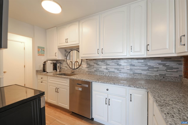 kitchen featuring white cabinets, dishwasher, and tasteful backsplash
