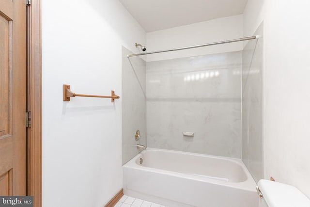 bathroom featuring toilet,  shower combination, tile patterned flooring, and baseboards