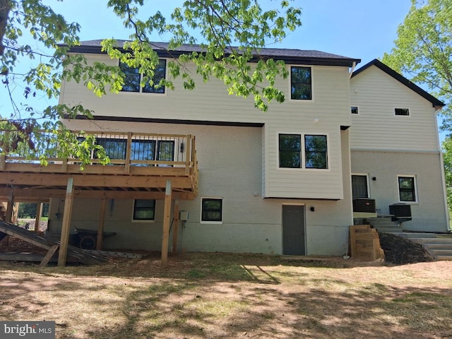 rear view of property featuring a wooden deck
