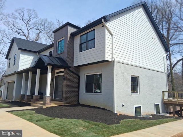 view of front of home featuring brick siding