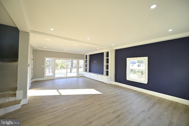 unfurnished living room with baseboards, recessed lighting, and wood finished floors