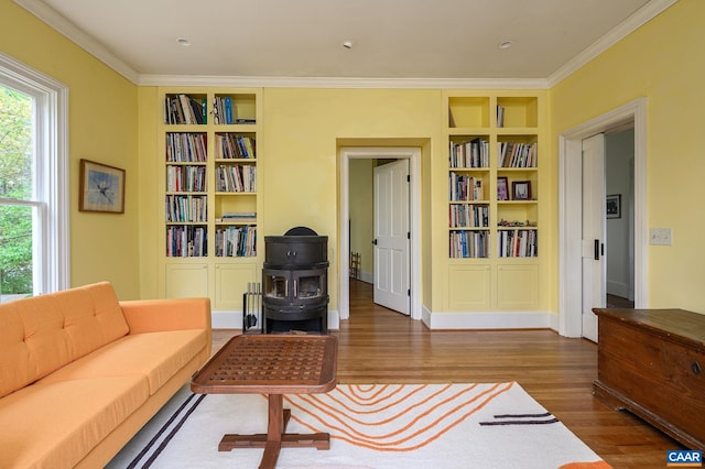 1112 Park St, Charlottesville, VA 22901 - living room with built in shelves, crown molding, and wood finished floors
