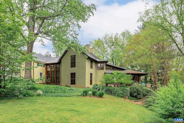 1112 Park St, Charlottesville, VA 22901 - view of side of property with a yard, stucco siding, a metal roof, a standing seam roof, and a chimney
