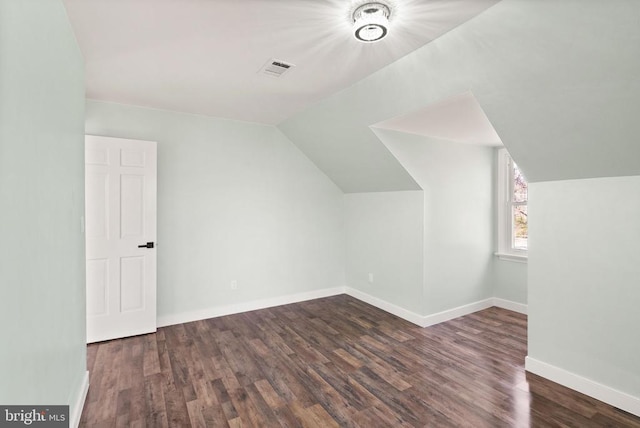 bonus room featuring vaulted ceiling, wood finished floors, visible vents, and baseboards