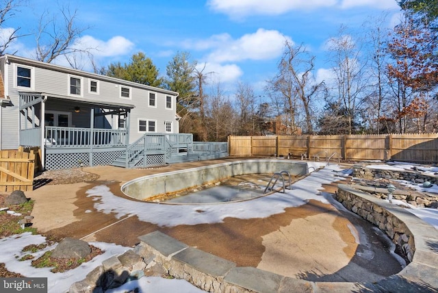 view of swimming pool with a fenced backyard, a fenced in pool, and a deck