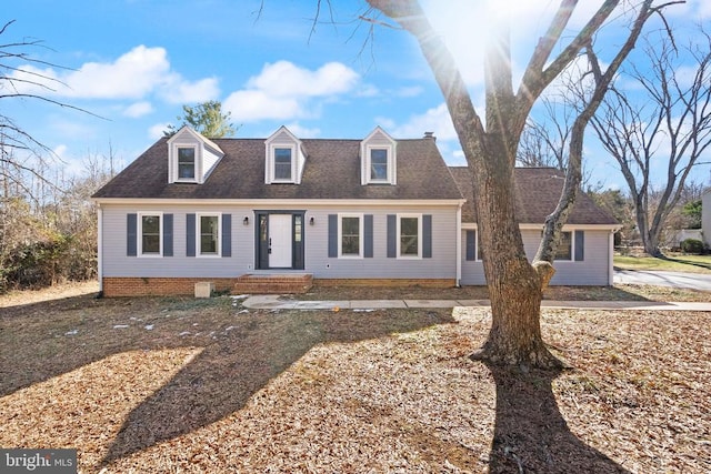 cape cod-style house featuring roof with shingles and crawl space