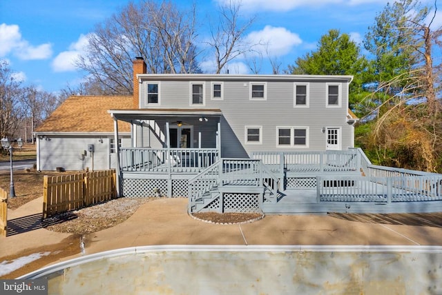 rear view of property featuring a chimney