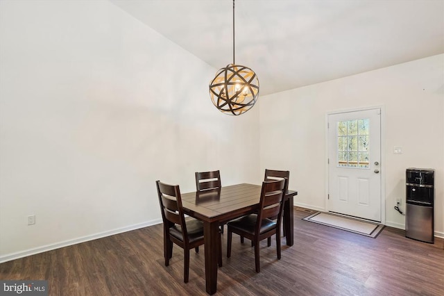  - dining area featuring a chandelier and dark wood-style flooring
