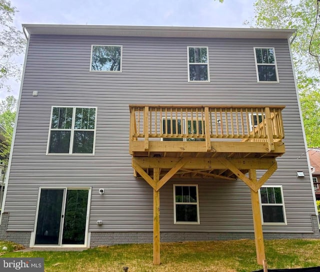 rear view of house with a wooden deck