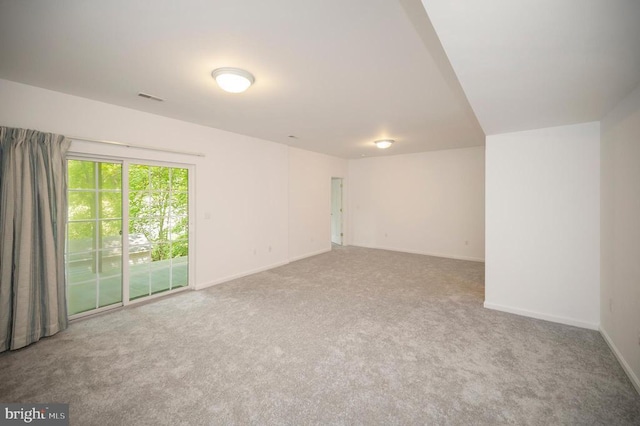 empty room featuring carpet flooring and baseboards