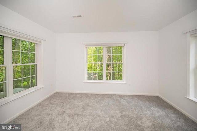 carpeted empty room with baseboards
