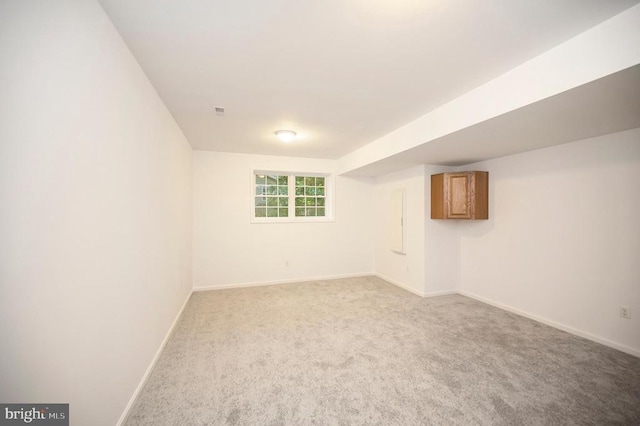 basement with baseboards and carpet