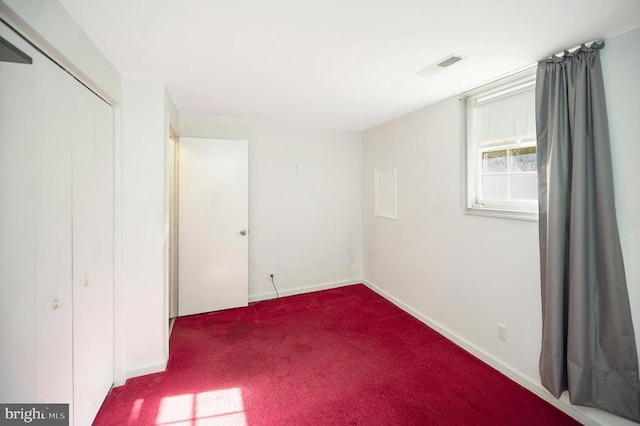 unfurnished bedroom with carpet floors and a closet